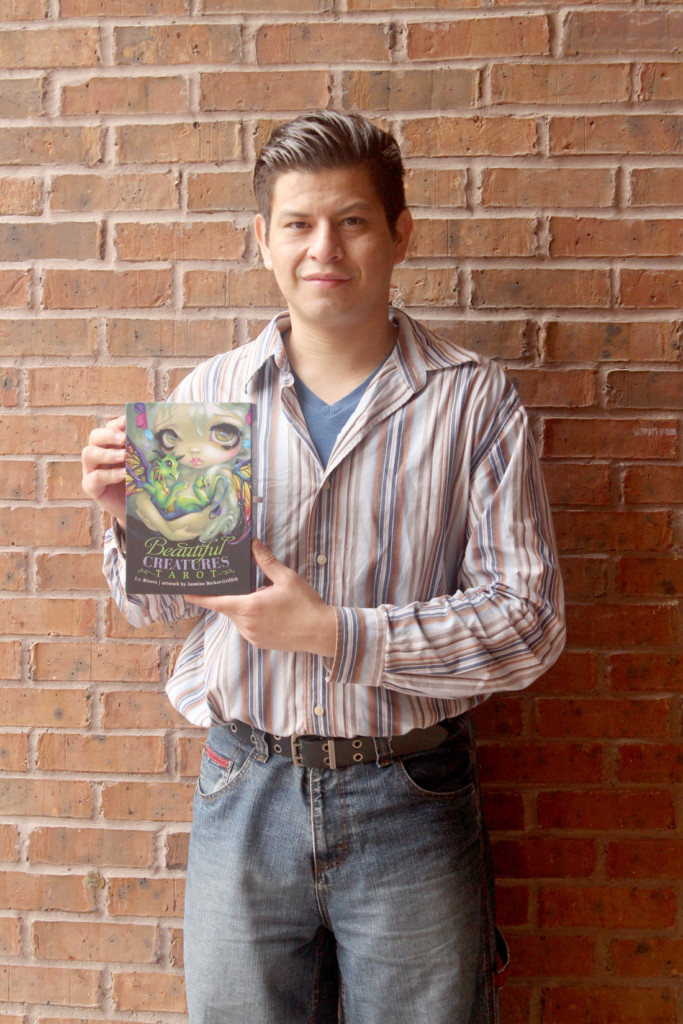 Jose Rolando Rivera holds the book “Beautiful Creatures Tarot.” Rivera contributed ideas to his publisher to produce the cover.