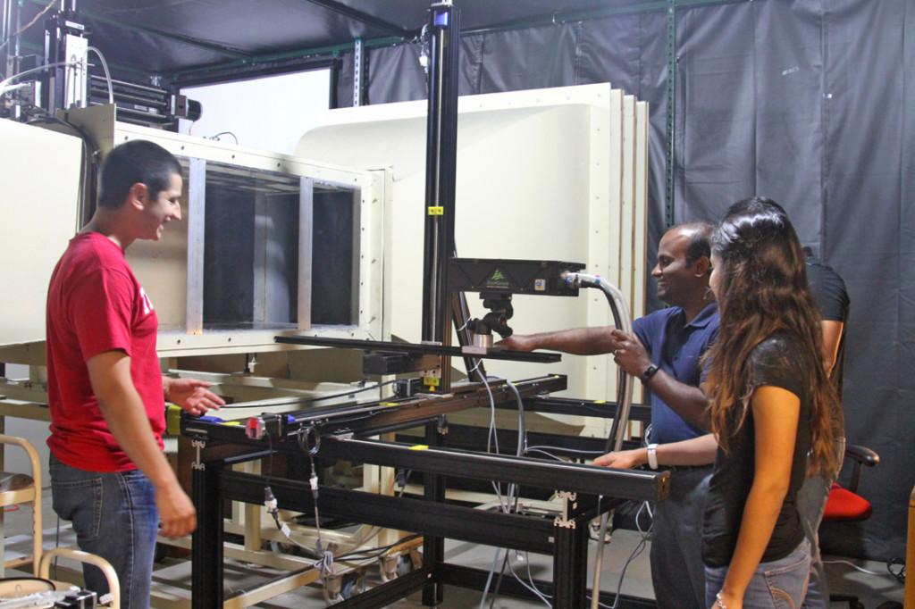 Mechanical engineering seniors Cesar Leos and Alexandra Alaniz gather around Isaac M. Choutapalli, an assistant professor of mechanical engineering and co-principal investigator of the U.S. Defense Department grant, on Sept. 20 at the Aerodynamics and Propulsion Laboratory in the Engineering building on the Edinburg campus. The federal grant will fund equipment and instrumentation for further investigation in aerodynamic properties./Lesley Robles/ The Rider