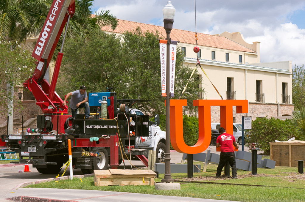 Workers install a UTRGV sign Sept. 12 outside the Student Union on the Brownsville campus. A similar sign has been installed on the Edinburg campus./Mario Gonzalez/The Rider