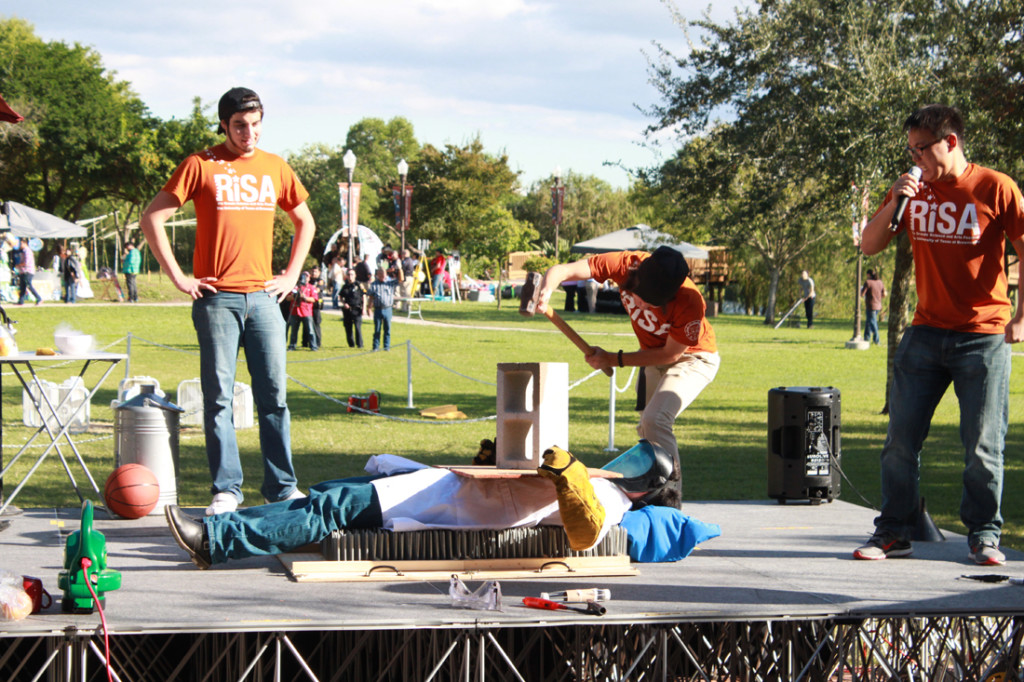 A student is about to smash a cinder block on a person lying on a bed of nails, without causing harm, as part of the 2014 Rio Grande Science and Arts (RiSA) Festival physics circus./The Rider File Photo