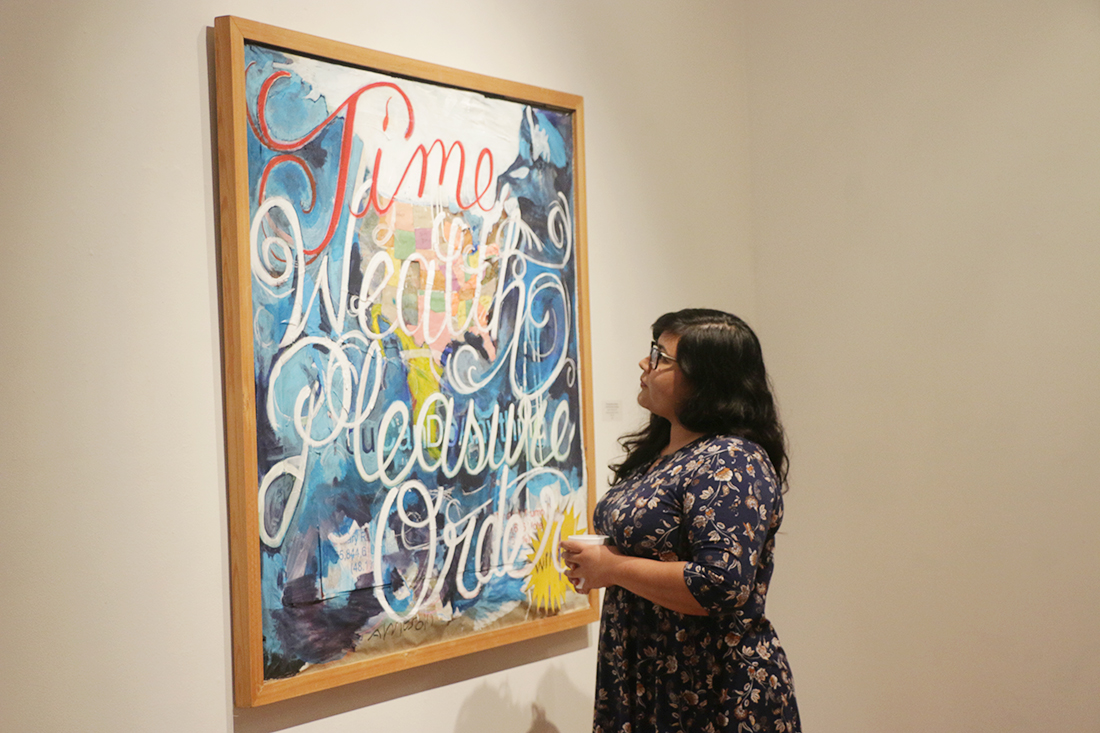 Studio art graduate student Josie Del Castillo observes the art piece titled, “The Negotiation of Country in the Direction of its Destiny,” (acrylic, tempera, vinyl on paper mounted on canvas) by artist David Alcantar during the exhibit “Minding the Gaps,” which opened Oct. 31 in the Art Gallery at Rusteberg Hall on the Brownsville campus.