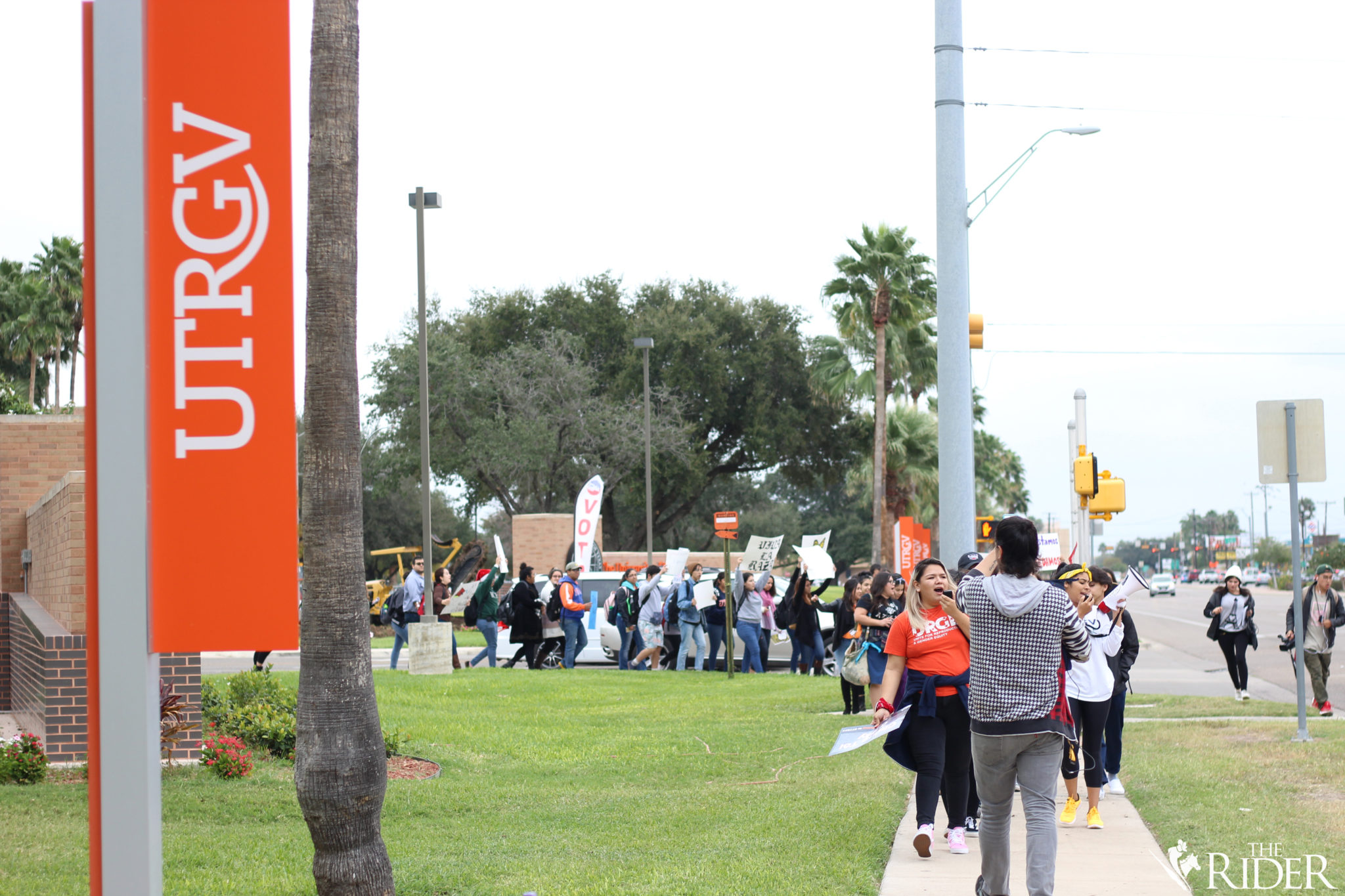 Protesters march to the corner of Sugar Road and University Boulevard during the “Solidarity Walkout” earlier today.