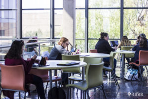 A picture of students studying on a building.