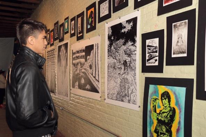 Rolando Torres views a print during last year’s #Subculture: Urban Art Experience. The exhibit, held at the Brownsville Arts and Musicians building on East Adams Street, featured a silk screening and linoleum print workshop.