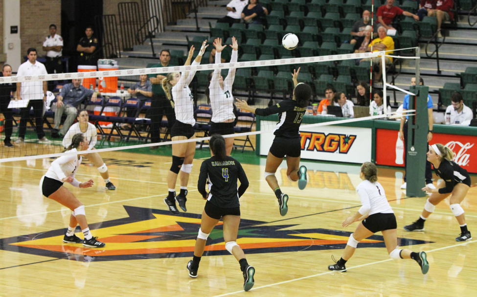 UMKC’s Mykal Sadler attempts to send a ball past two UVU defenders during their quarterfinals match in the UTRGV Fieldhouse as part of the WAC Tournament.