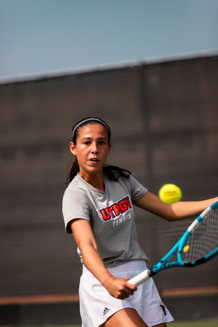 Tennis player Valeria Montero setting hitting a tennis ball.