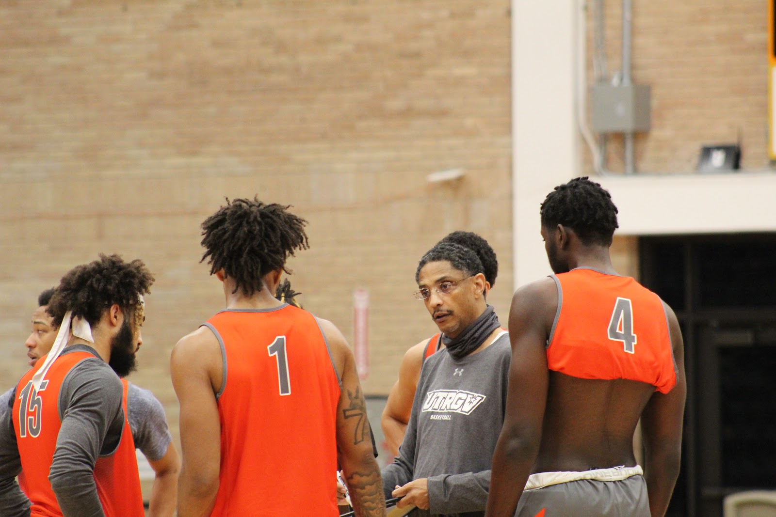 Head Coach Lew Hill discusses strategies with his players during practice