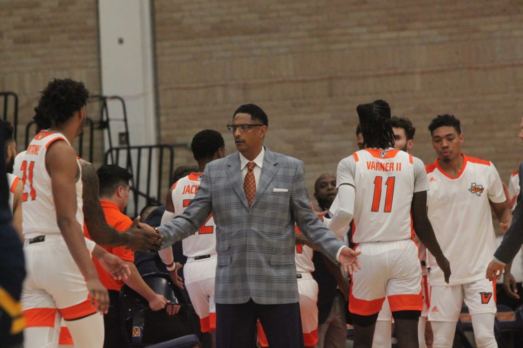 UTRGV Men’s Basketball Head Coach Lew Hill greets his players during a home game on Nov. 18, 2019.     The Rider File Photo