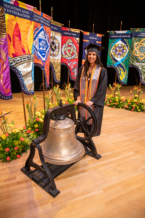 Spring Commencement Bell Ringer Briana Cortez stands next to the bell during the ceremony on May 30, 2020.   Photo Courtesy Cindy Mata-Vasquez