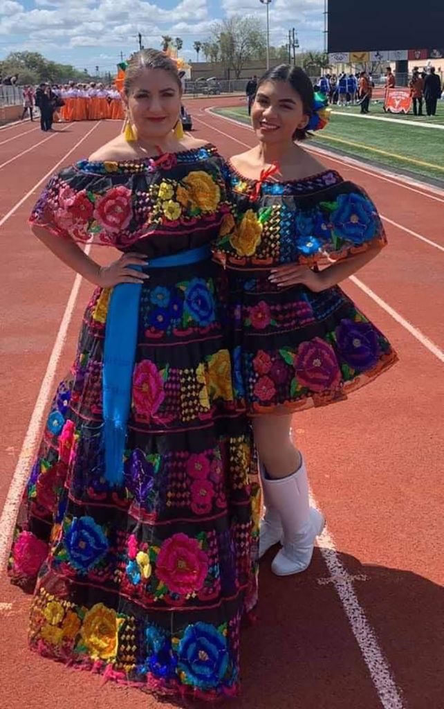 Yliana Guzman (left), owner of Camelia Mexican Boutique, poses with her youngest daughter, Yvanna Guzman, at Sams Memorial Stadium in Brownsville, before the start of a Charro Days parade last year. Guzman and her daughter are wearing costumes the boutique sells for the Charro Days festival.  Photo Courtesy Yliana Guzman 