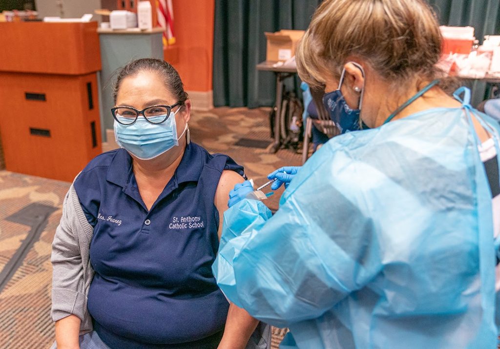 Maggie Juarez, office manager at St. Anthony Catholic Church, receives the Pfizer vaccine March 5 at the UTRGV Clinical Education Building in Harlingen. David Pike/University Marketing and Communications