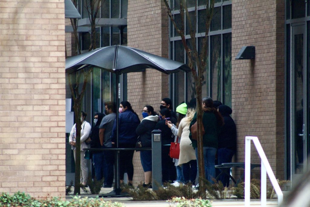 People wait in line March 1 to receive the COVID-19 vaccine outside the UTRGV School of Medicine in Edinburg. Jacqueline Wallace/The Rider Photo