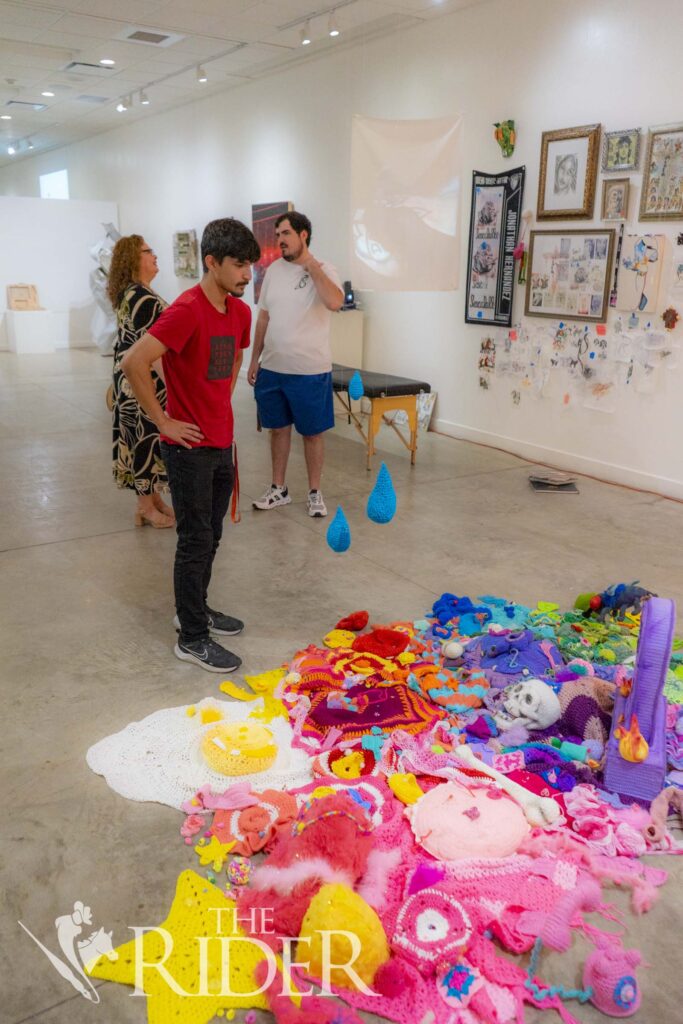 Brownsville resident Luis Andres Sierra admires the details in Mariana Prado’s “Petateado,” (crocheted yarn, fleece, felted wool, foam clay and pursued objects). Eduardo Escamilla/THE RIDER