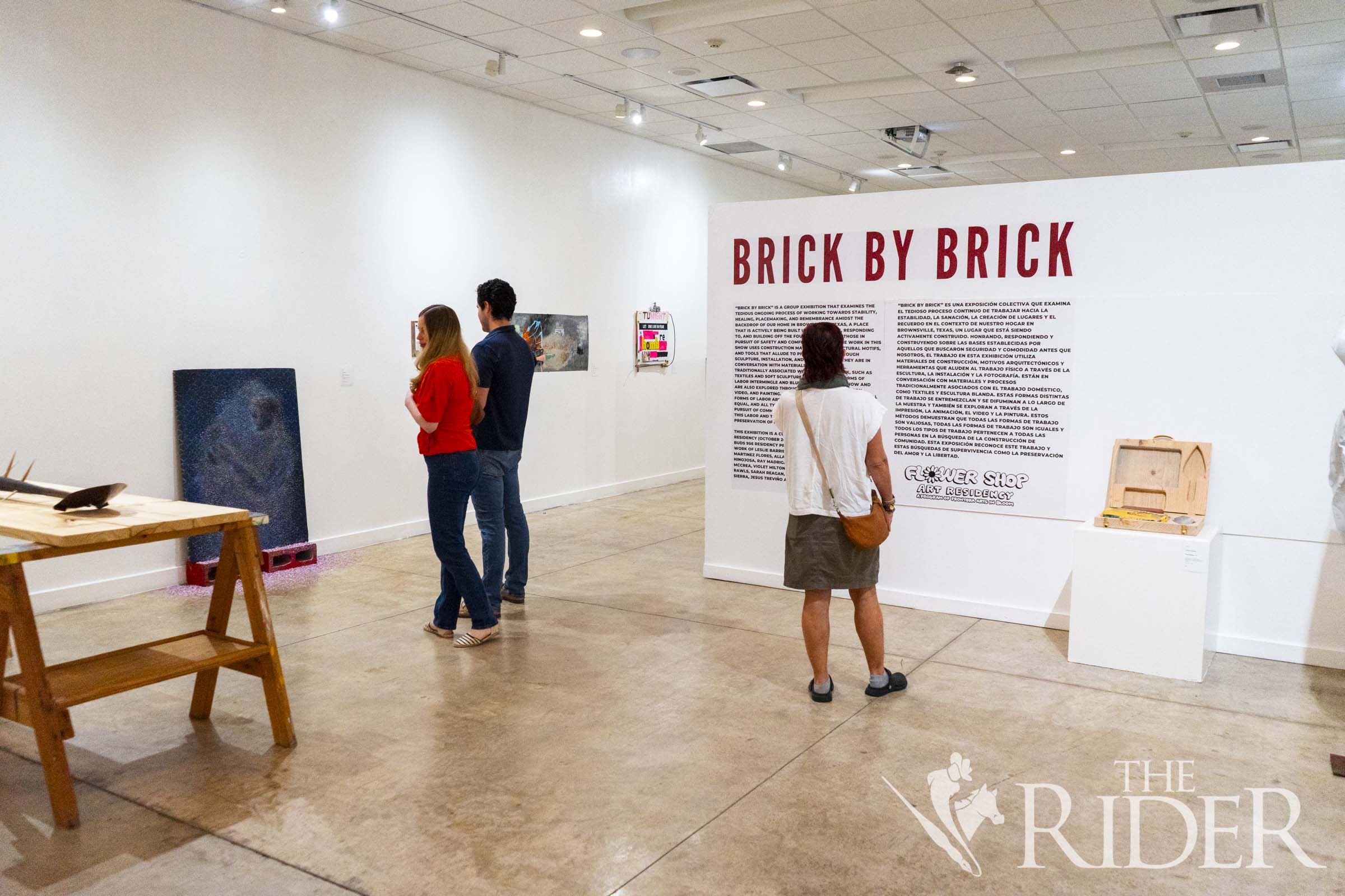 Museumgoers explore the opening reception of “Brick by Brick,” a group exhibition honoring the foundations laid by community builders and others in pursuit of safety and comfort. The exhibit is now on view through Sept. 13 at the Brownsville Museum of Fine Art, located at 660 E. Ringgold St. Eduardo Escamilla/THE RIDER