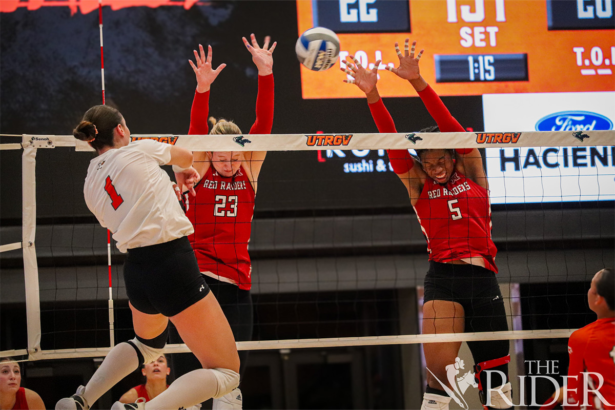 Vaqueros senior outside hitter Claudia Lupescu attacks against Raiders graduate student right-side hitter Emily Merrick (left) and graduate student middle blocker Aliyah McDonald during tonight’s game in the UTRGV Fieldhouse on the Edinburg campus. The first home game of the season drew 2,771 attendees. The Vaqueros lost 3-2. Abigail Ollave/THE RIDER