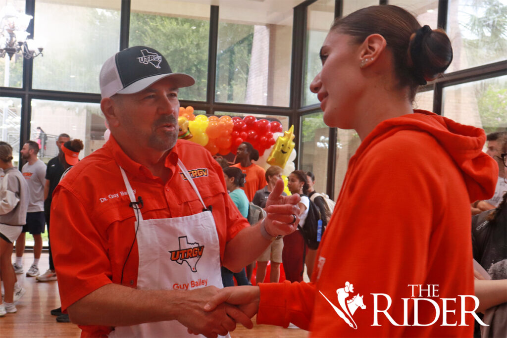 UTRGV President Guy Bailey greets Claudia Lupescu, a marketing senior and outside hitter for the UTRGV Volleyball Team, as she waits in line for her burger during Picnic with the President Wednesday afternoon in the University Ballroom on the Edinburg campus.
Angel Ballesteros/THE RIDER