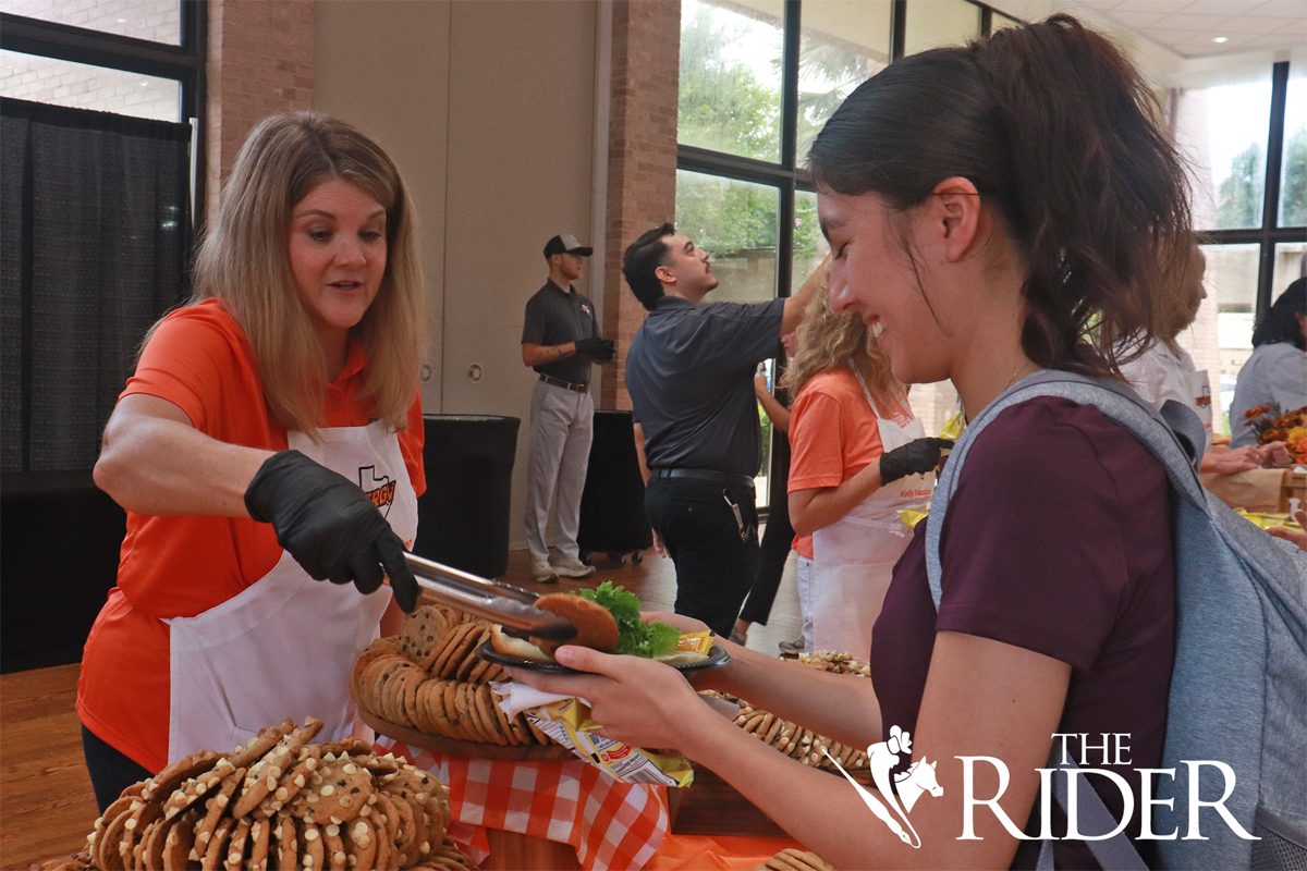 UTRGV Chief of Staff Samantha Allen serves finance senior Adriana Leos a cookie during Picnic with the President Wednesday afternoon in the University Ballroom on the Edinburg campus. Angel Ballesteros/THE RIDER