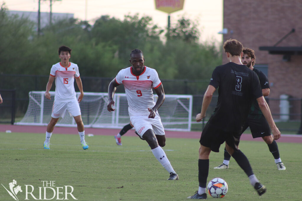 Vaqueros junior forward Kgodiso Sukati runs toward Dolphins graduate defender Matthew Skinner in an attempt to steal the ball Thursday at the UTRGV Soccer and Track & Field Complex on the Edinburg campus. Raquel Cazares/THE RIDER