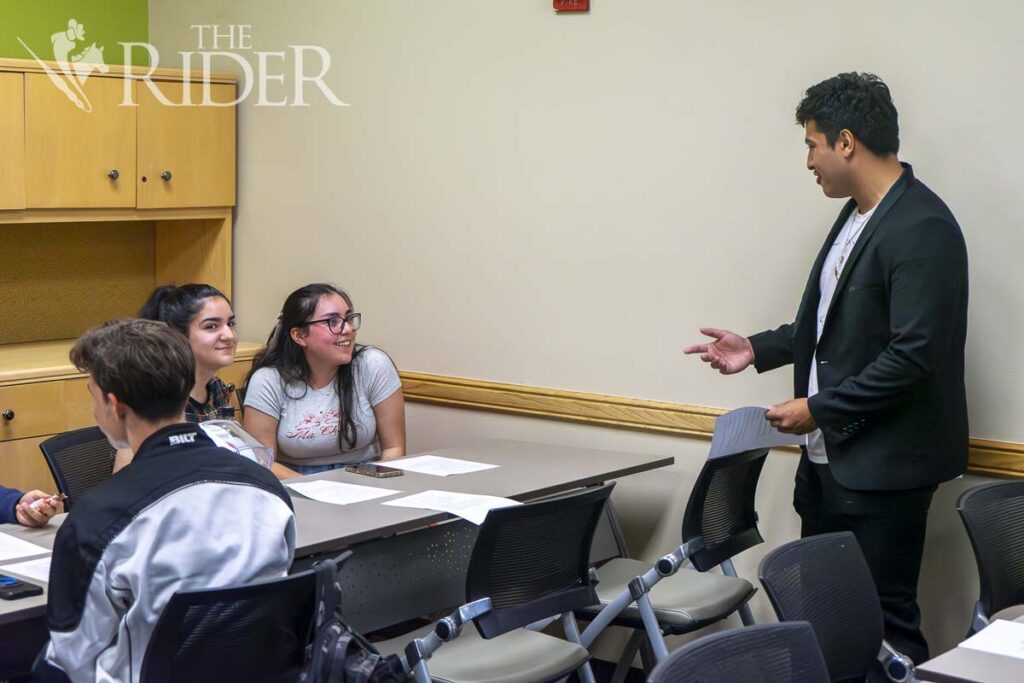 Kevin Flores, a computer science sophomore and Team Victoriam member, chats with integrated health science freshman Joleth Gomez (left) and psychology freshman Emily Guerra during the “Fall For Me” speed dating event Thursday in the Student Union Sage Room on the Edinburg campus. Eduardo Escamilla/THE RIDER