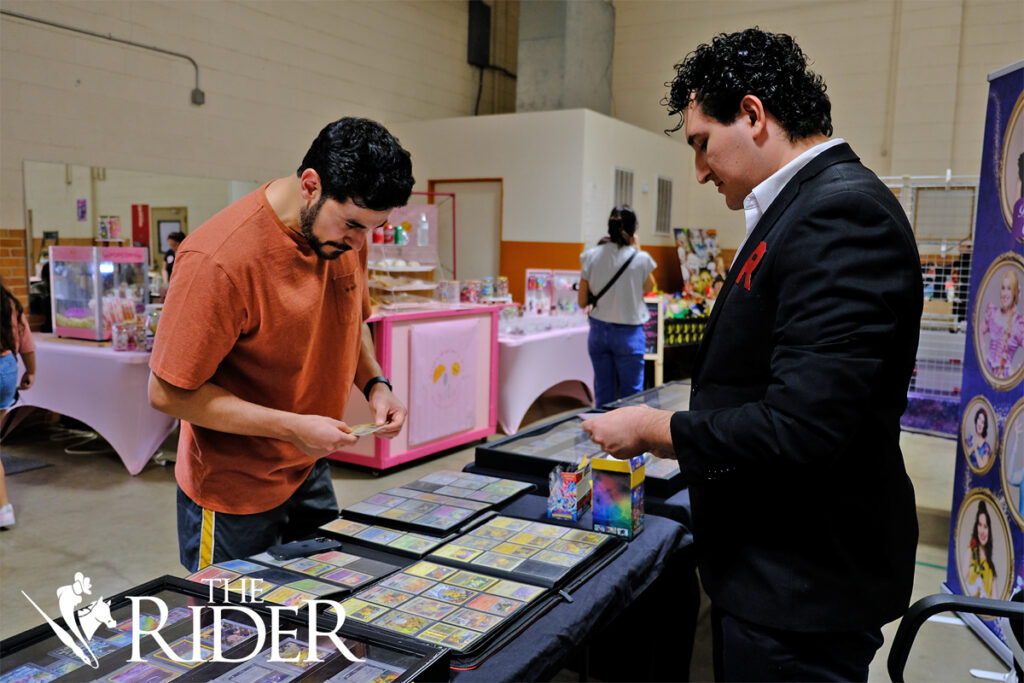 Mission resident Ramiro Diaz browses through binders of Pokémon cards at the Bosswatch Gaming booth during the RGV PokéFest Sept. 21 in the Mission Parks and Recreation building. Diaz said his favorite Pokémon is Bulbasaur. Also pictured is Ricky Perez, the owner of Bosswatch Gaming. Angel Ballesteros/THE RIDER