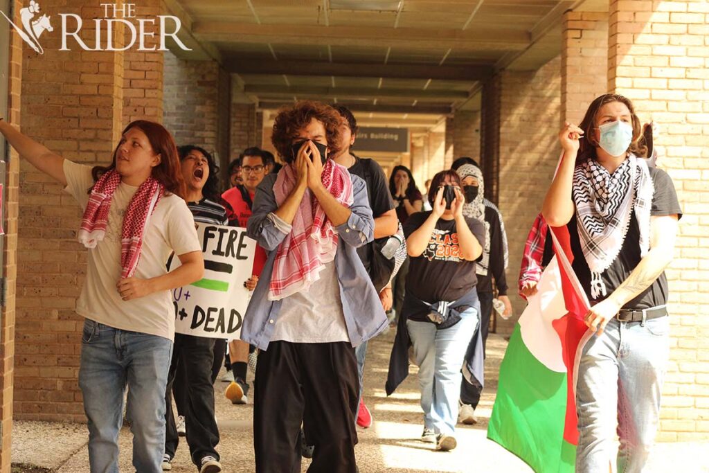 Protesters chant Oct. 7 on the Bronc Trail during the Palestine Lebanon Solidarity Rally on the Edinburg campus. About 50 people took part in the rally. Raquel Cazares/THE RIDER