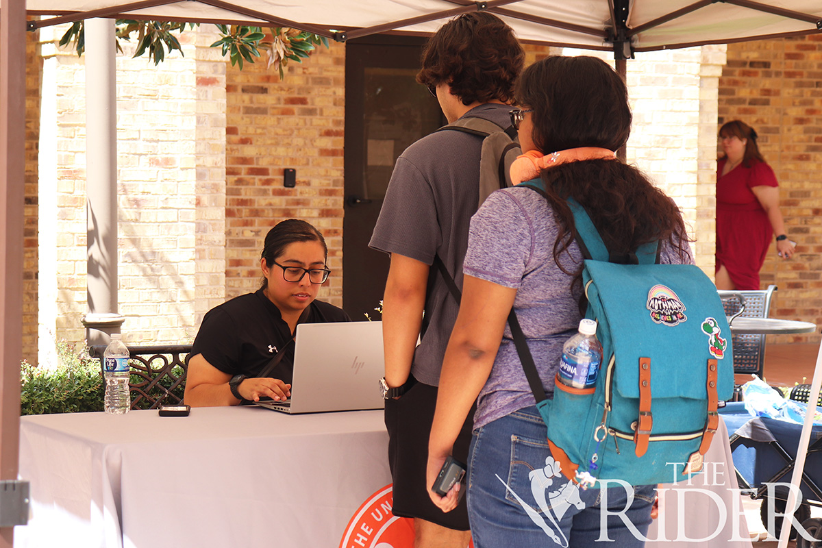 Student Government Association Program Coordinator Kourtnie Hernandez signs in students Tuesday at the SGA tabling event. Students were asked to complete a survey in the Main Building Courtyard on the Brownsville campus. Silvana Villarreal/THE RIDER